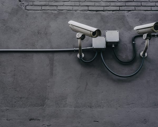 pexels-photo-430208-430208 Two surveillance cameras mounted on a concrete wall, highlighting security technology.